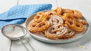 Golden fry bread drizzled with honey and powdered sugar on a rustic wooden platter.