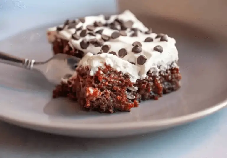 Better Than Sex Cake as the centerpiece on a decorated party table with plates and champagne glasses.