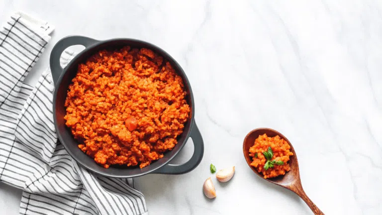 "A bowl of fluffy, golden Mexican rice garnished with fresh cilantro and lime wedges, served alongside a colorful spread of Mexican dishes."