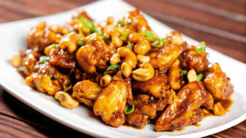 Close-up of cashew chicken stir-fry with golden chicken pieces and toasted cashews.